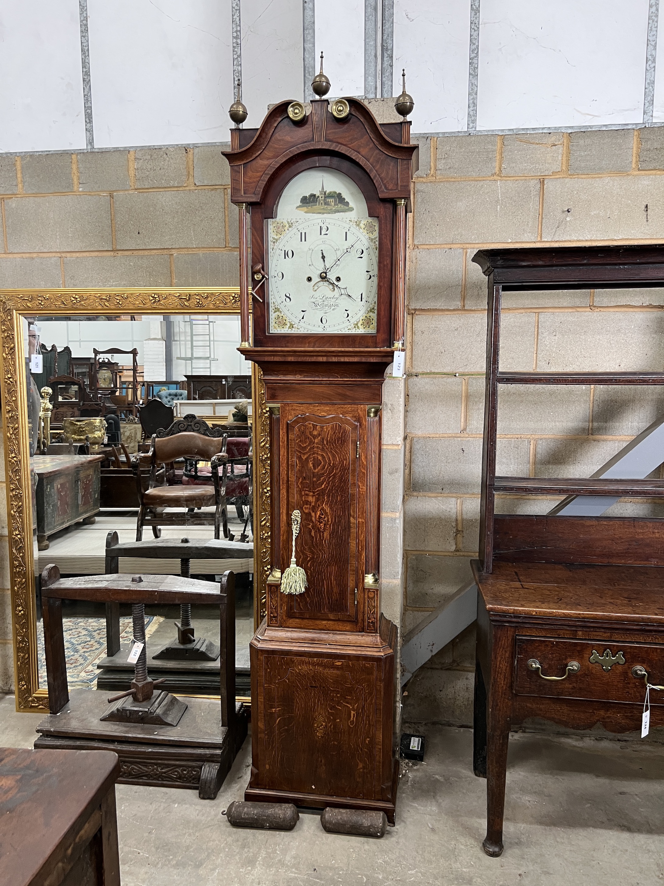 A late 18th century mahogany banded oak eight day longcase clock, with an arched painted dial marked Lanley, Wellington, height 228cm